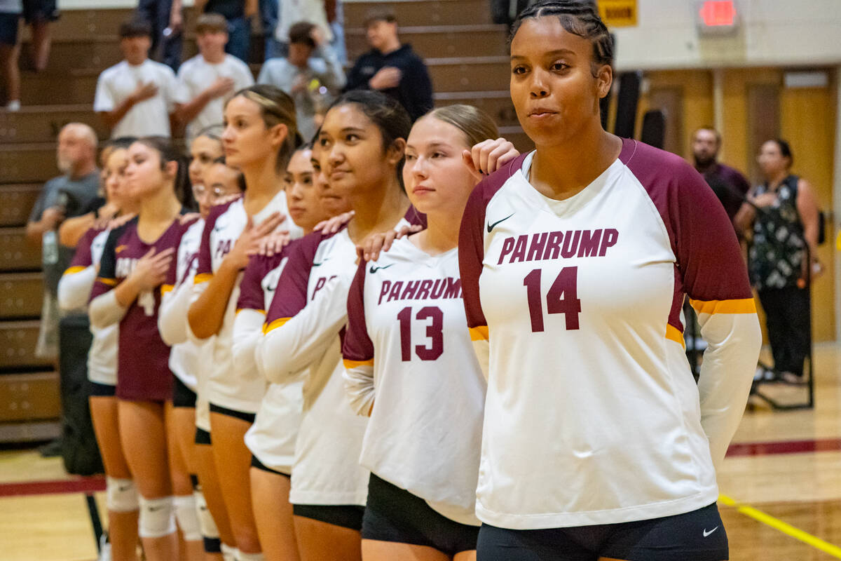 The Pahrump Valley High School girls volleyball team stands for the national anthem before a le ...