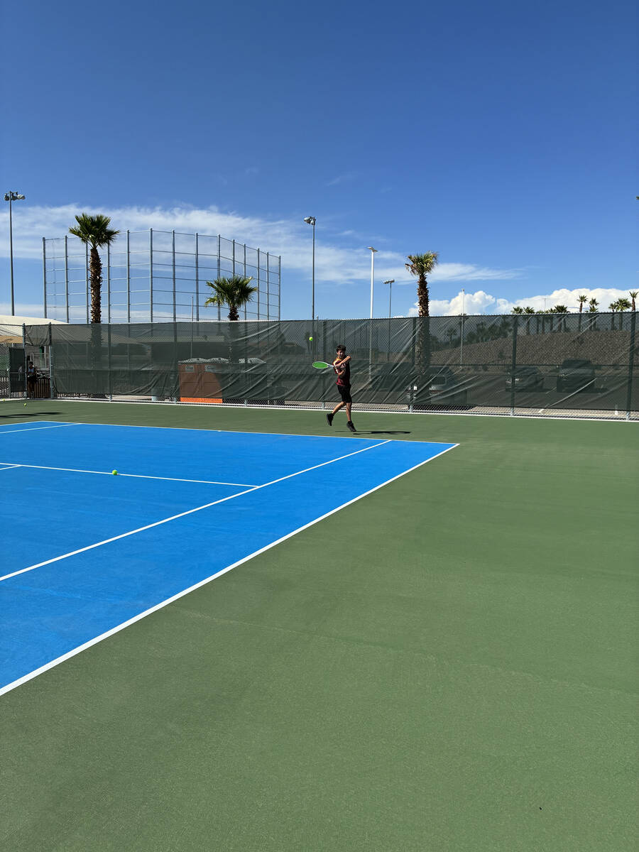 Pahrump Valley High School tennis sophomore Jace Eichner returns a hard serve in a singles matc ...