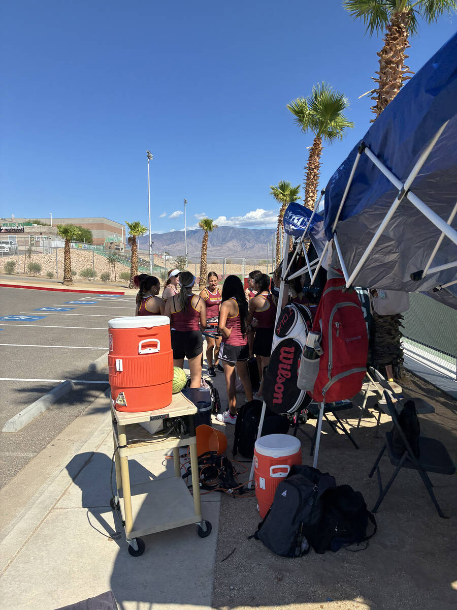 The Pahrump Valley High School girls tennis team celebrates after a dominant win 11-6 against l ...