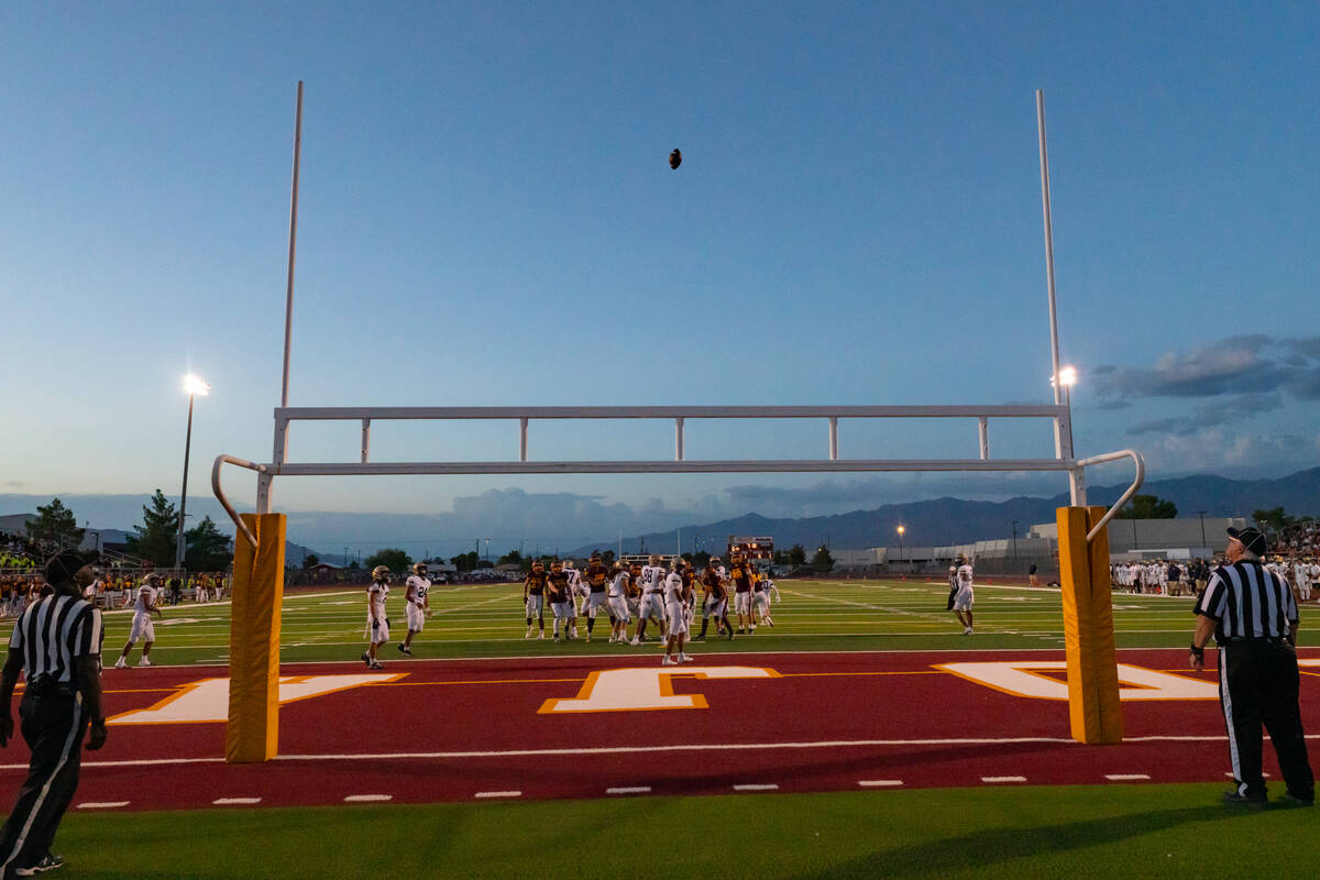 Pahrump Valley High School senior RB/LB/K Joshua Slusher kicks an extra point through the up-ri ...
