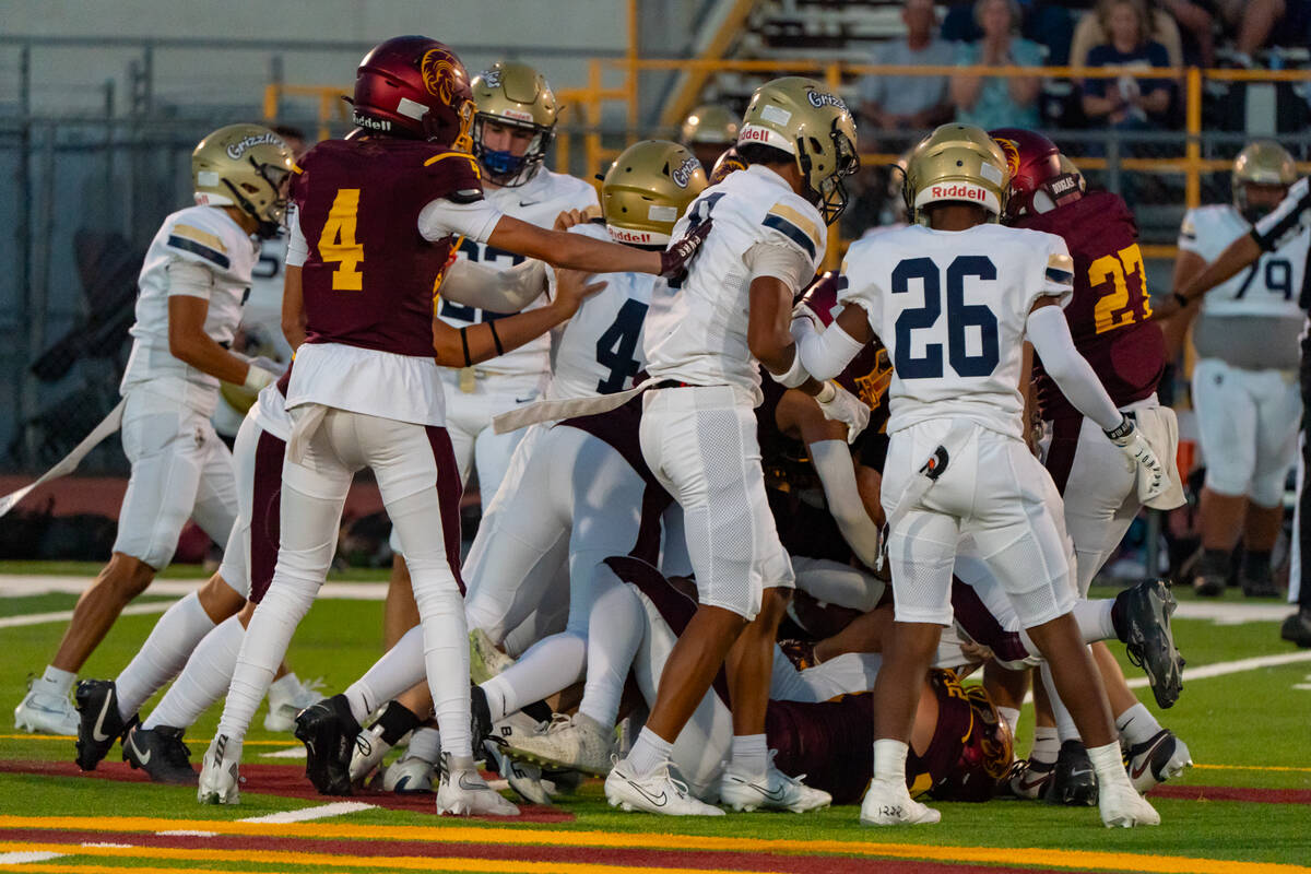 Pahrump Valley High School senior RB/LB leads the dogpile as the Trojans fell to Spring Valley ...