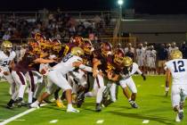 Pahrump Valley High School junior wideout Ryan Hamlin carries the ball forward against Spring V ...