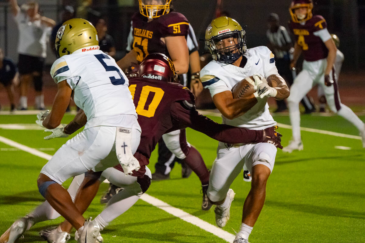 Pahrump Valley High School junior WR/S Lucas Gavenda attempts to wrap up Spring Valley High Sch ...