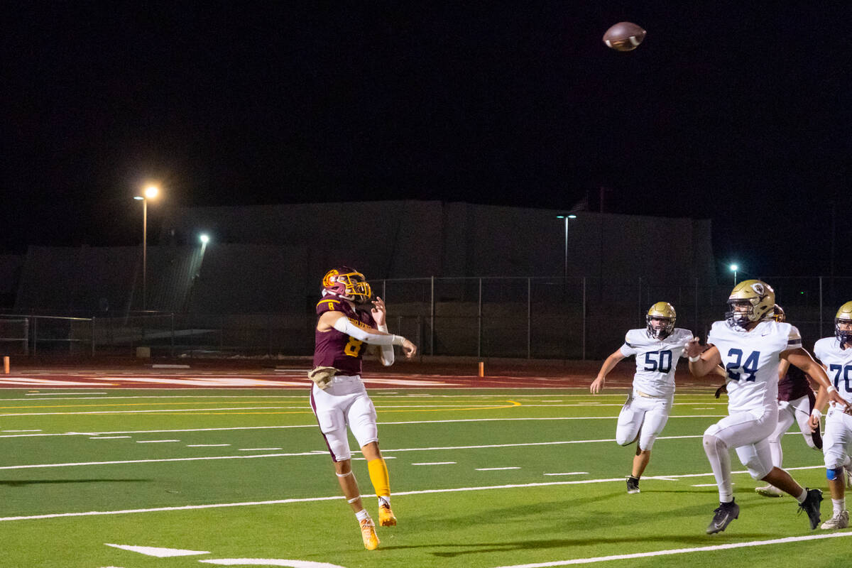 Pahrump Valley High School senior quarterback Kayne Horibe slings a pass deep against Spring Va ...