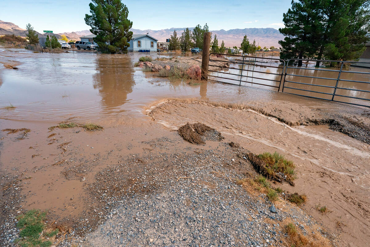 Near McMurray Dr., the rush of flood waters carved out portions of the roadway and Nye County P ...
