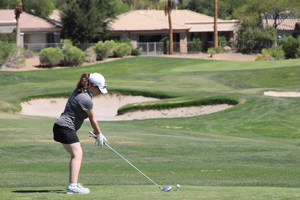 Pahrump Valley High School girls golf senior Tiffany Sartin sets up for her drive at Siena Golf ...