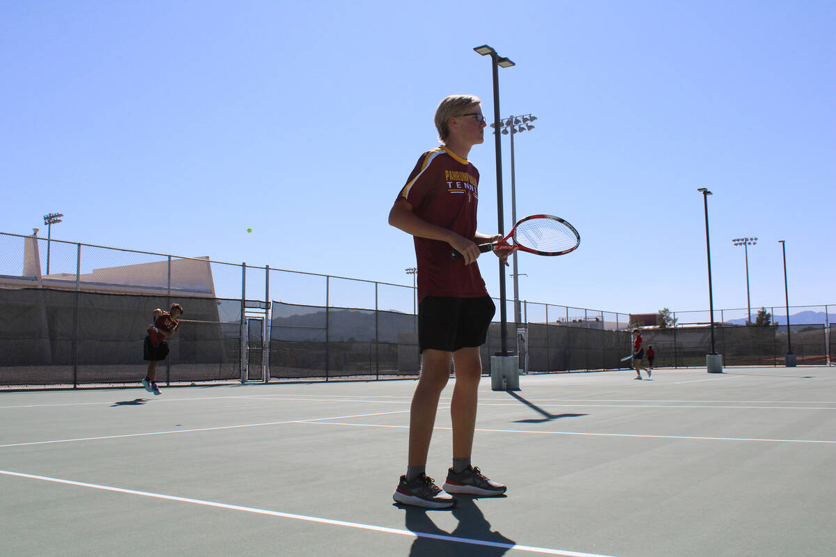 Pahrump Valley High School tennis doubles player Bryce Dykstra prepares to receive a serve in a ...
