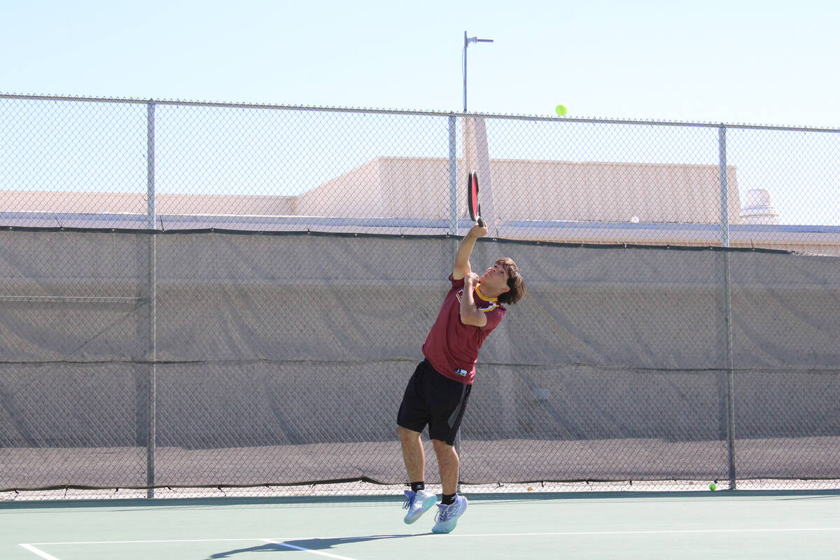 Pahrump Valley High School tennis doubles player Nicholas Watson serves up a nice ball in a hom ...