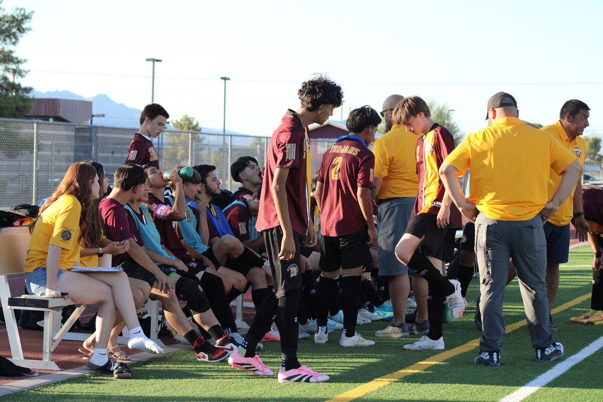 During a water break, Trojans soccer head coach Andrew Norton encourages his squad to keep up t ...