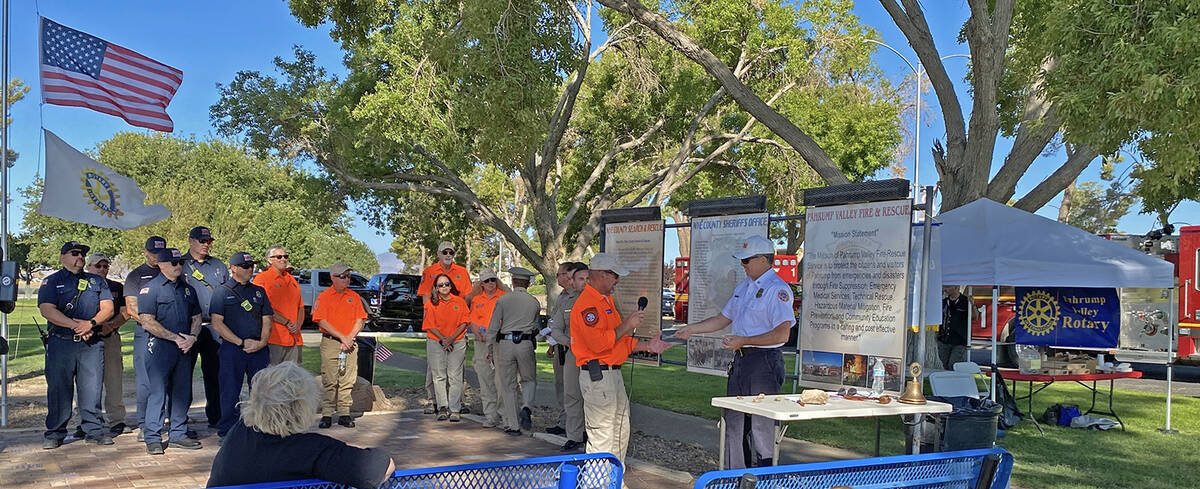 Pahrump fire chief Scott Lewis presented commemorative coins to each of the first responders at ...