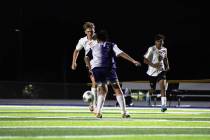 Pahrump Valley High School junior midfielder TC Hone dribbles past The Meadows defender in an a ...