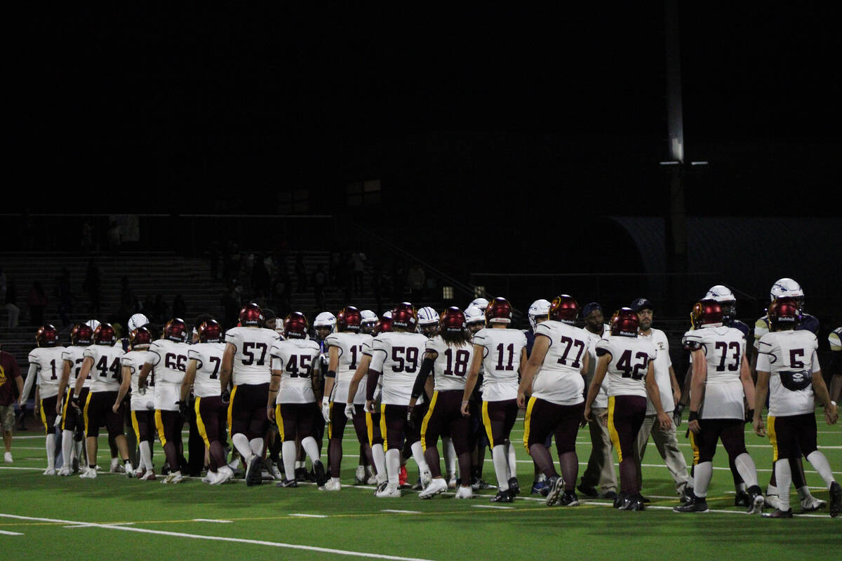 Pahrump Valley High School Trojans line up to shake hands with Cheyenne High School following ...