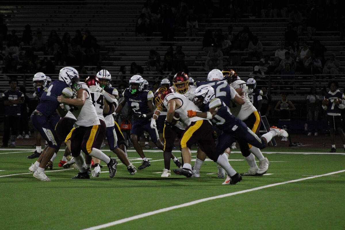 Pahrump Valley High School junior OG Preston Doctor blasts the A gap as the Trojans successfull ...