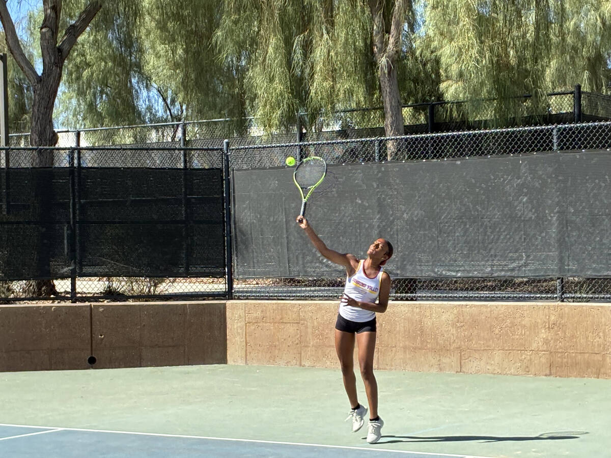 Pahrump Valley High School tennis junior Chanel Anthony serves up the ball in an away league ma ...