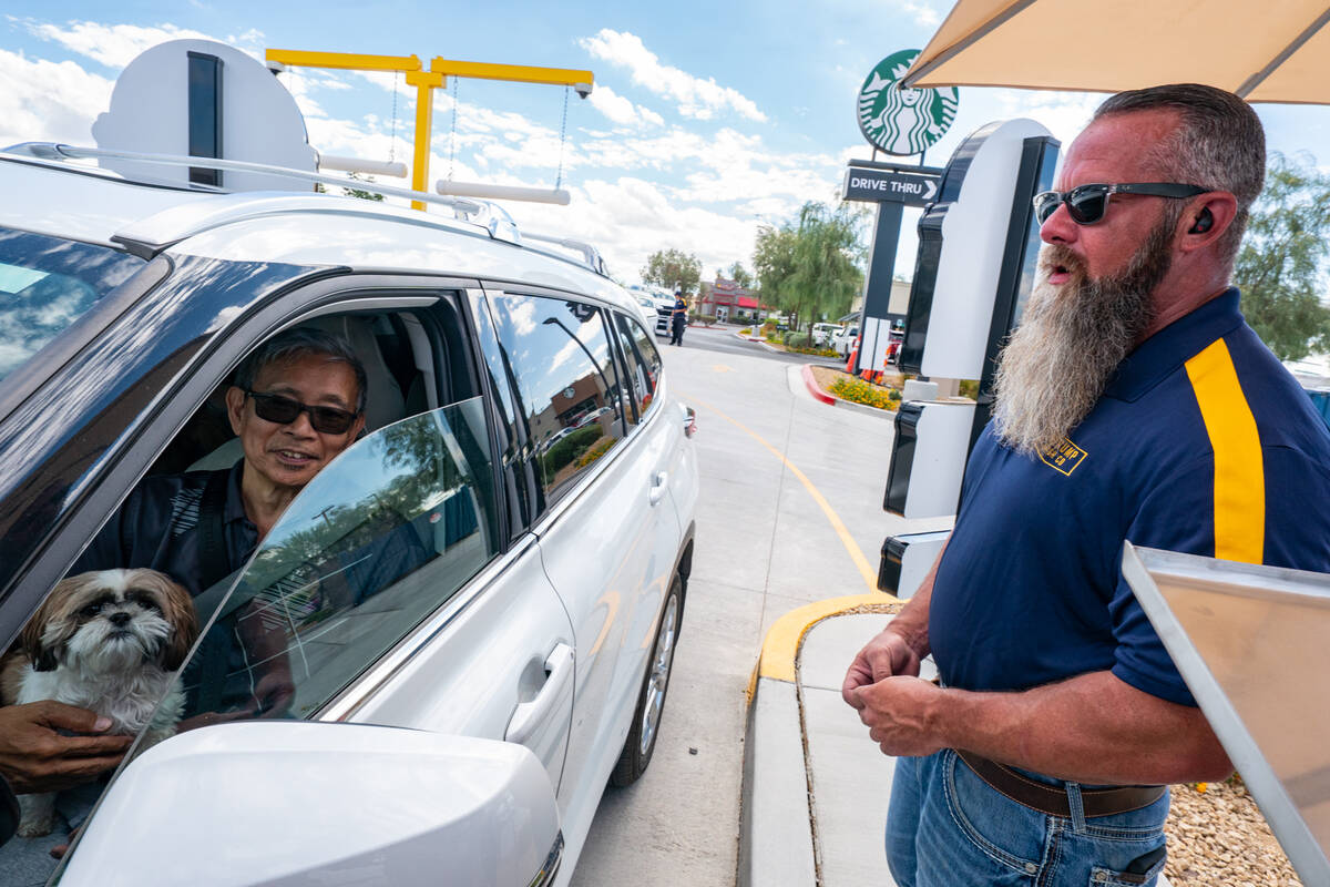 John Masters, who runs the operations at Pahrump Wash Co. greets customers at their grand openi ...