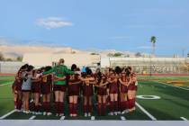 The Pahrump Valley High School girls soccer team gathers for a team prayer before the start of ...
