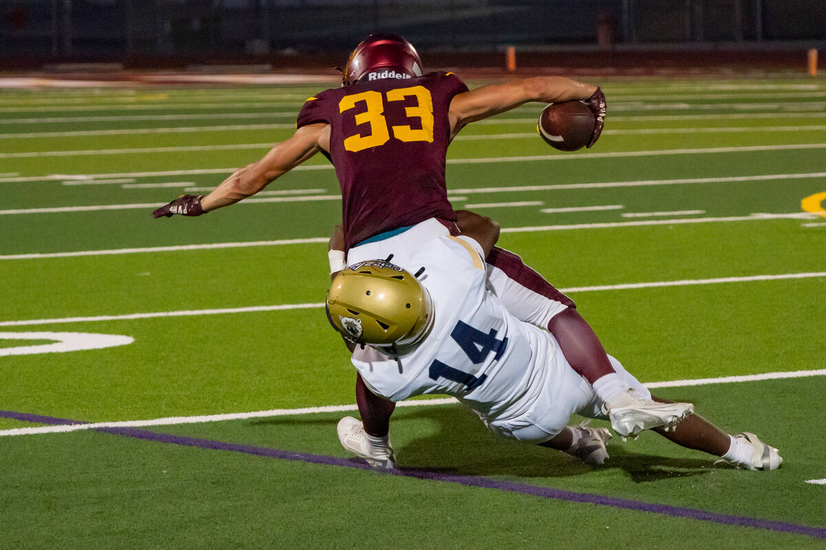 Pahrump Valley High School senior ATH/WR/FS Austin Alvarez tries to avoid being brought down in ...