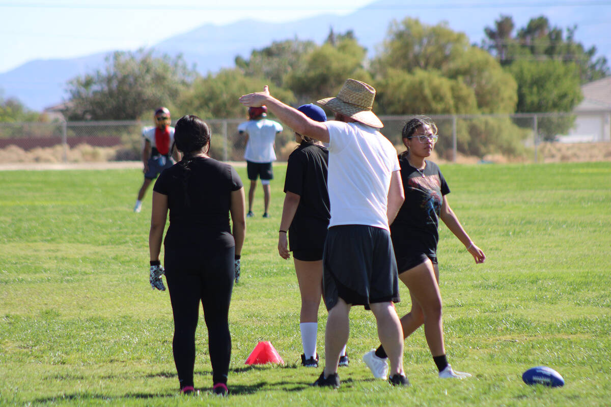 Pahrump Valley High School girls flag football head coach Jeff Corbett instructs players during ...