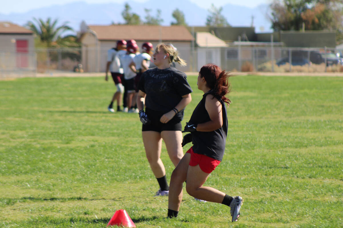 Pahrump Valley High School girls flag football sophomores Ari Lozoya and Abby Morrow practice r ...