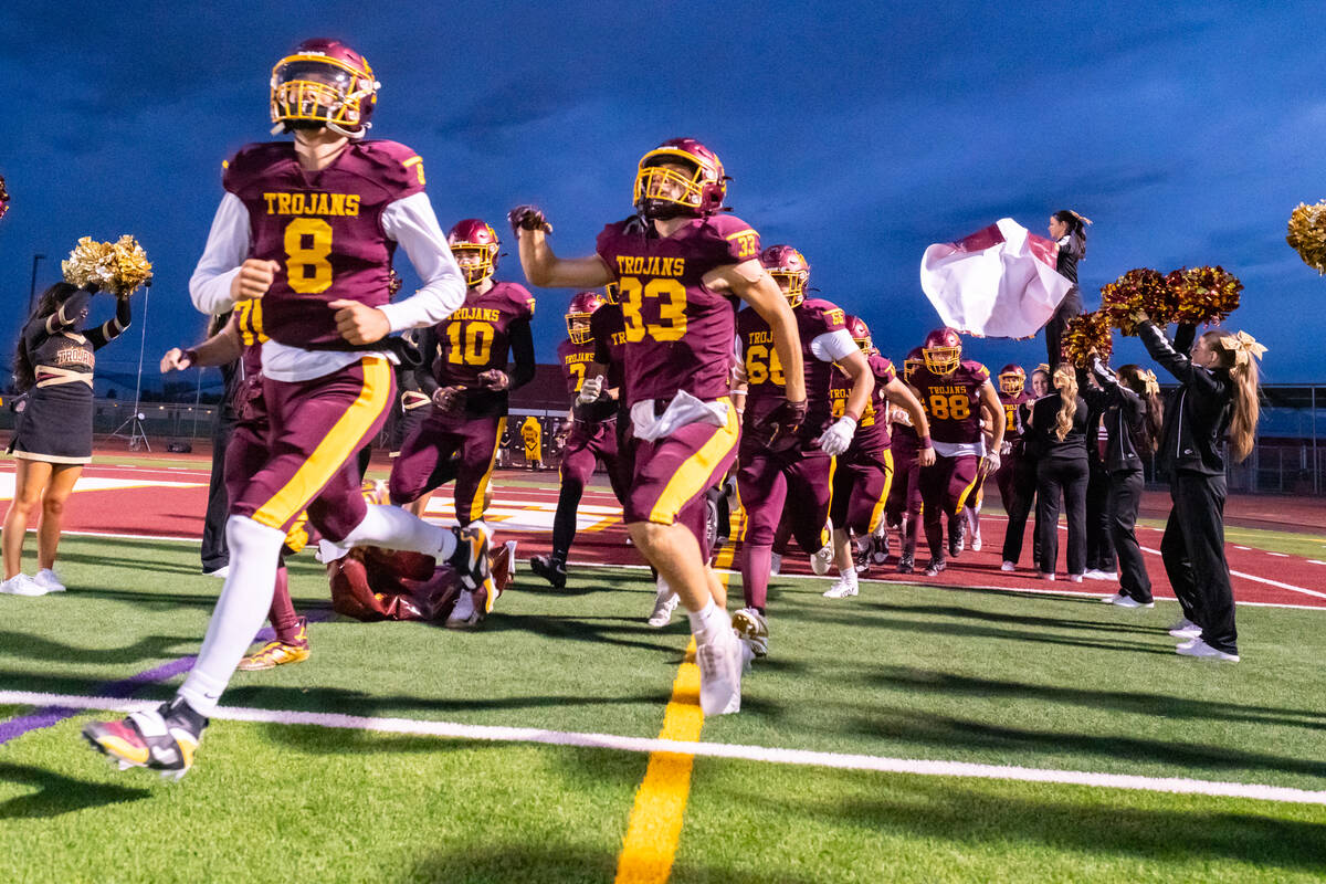 Pahrump Valley High School seniors Kayne Horibe and Austin Alvarez storm onto the field before ...
