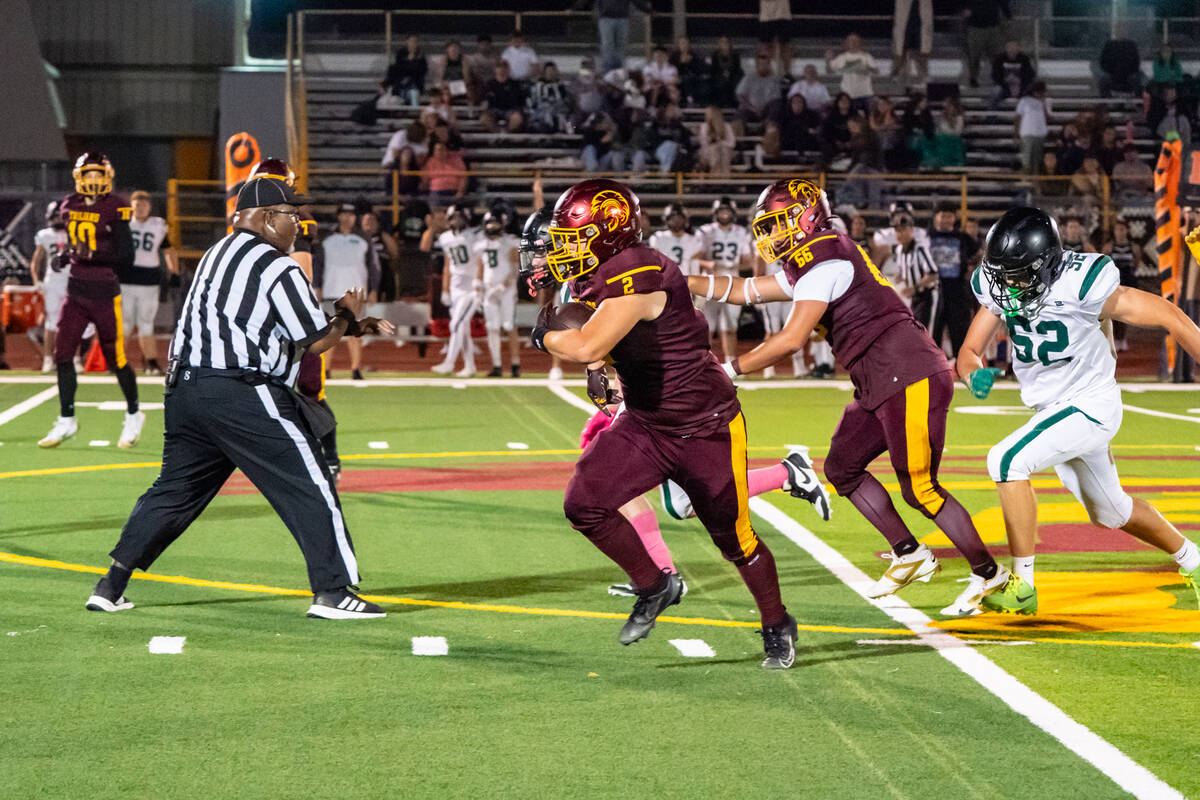 Pahrump Valley High School junior OG/RB Preston Dockter carries the ball forward for more yards ...