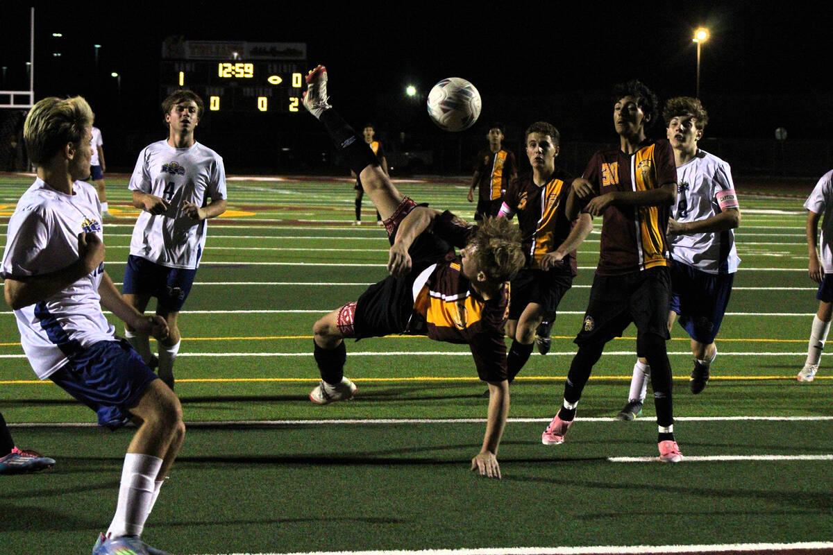PVHS boys soccer junior TC Hone attempts a bicycle kick during a home league match against Boul ...