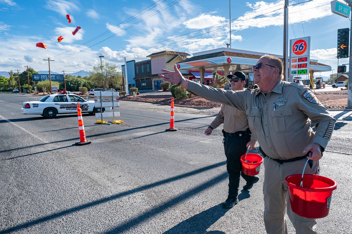 Nye County Sheriff Joe McGill tosses candy to the crowd at the Pahrump Fall Festival Parade, wh ...