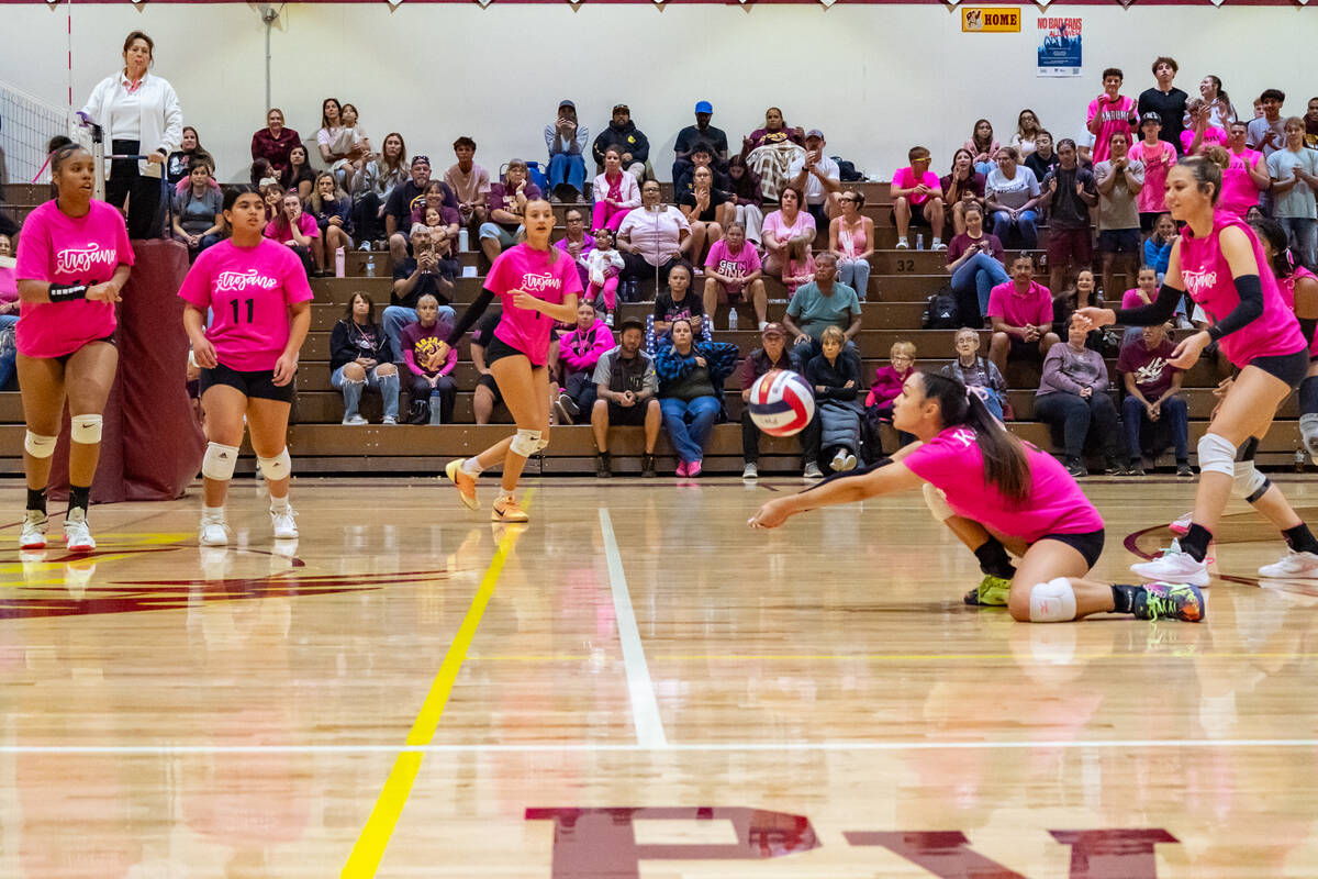 PVHS junior OH/RS Xe'ane Kamanu gets low to the ground to record a dig in a home league match v ...