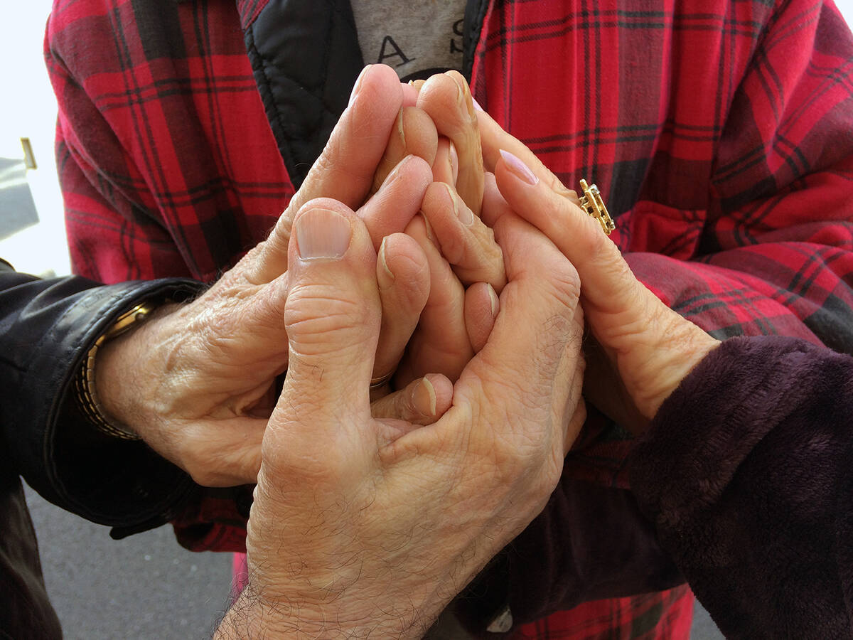 The late Tony (Lambardi) Laquidara clasped hands with fellow GriefShare founder members in a vi ...