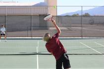 Pahrump Valley High School tennis player Bryce Dykstra serves to his opponent during his single ...