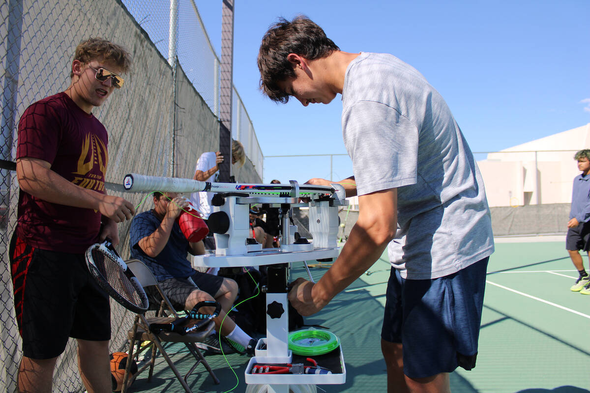 PVHS tennis player Jace Eichner restrings his tennis racket with a restringing machine that was ...