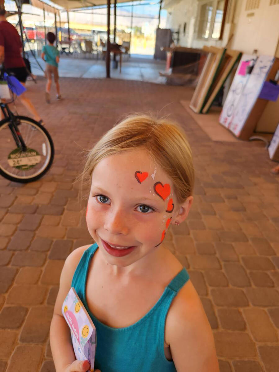 A Smiles Across Pahrump attendee gives a grin at the event as she displays the heart painted on ...