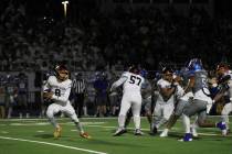 Pahrump Valley High School senior quarterback Kayne Horibe scrambles out of the pocket in an aw ...