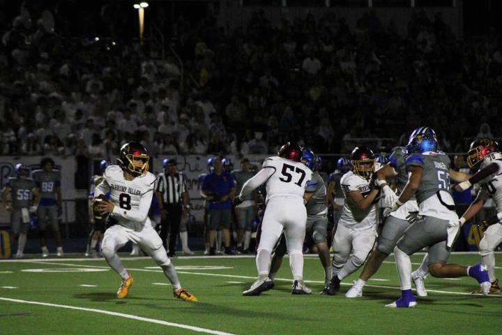 Pahrump Valley High School senior quarterback Kayne Horibe scrambles out of the pocket in an aw ...