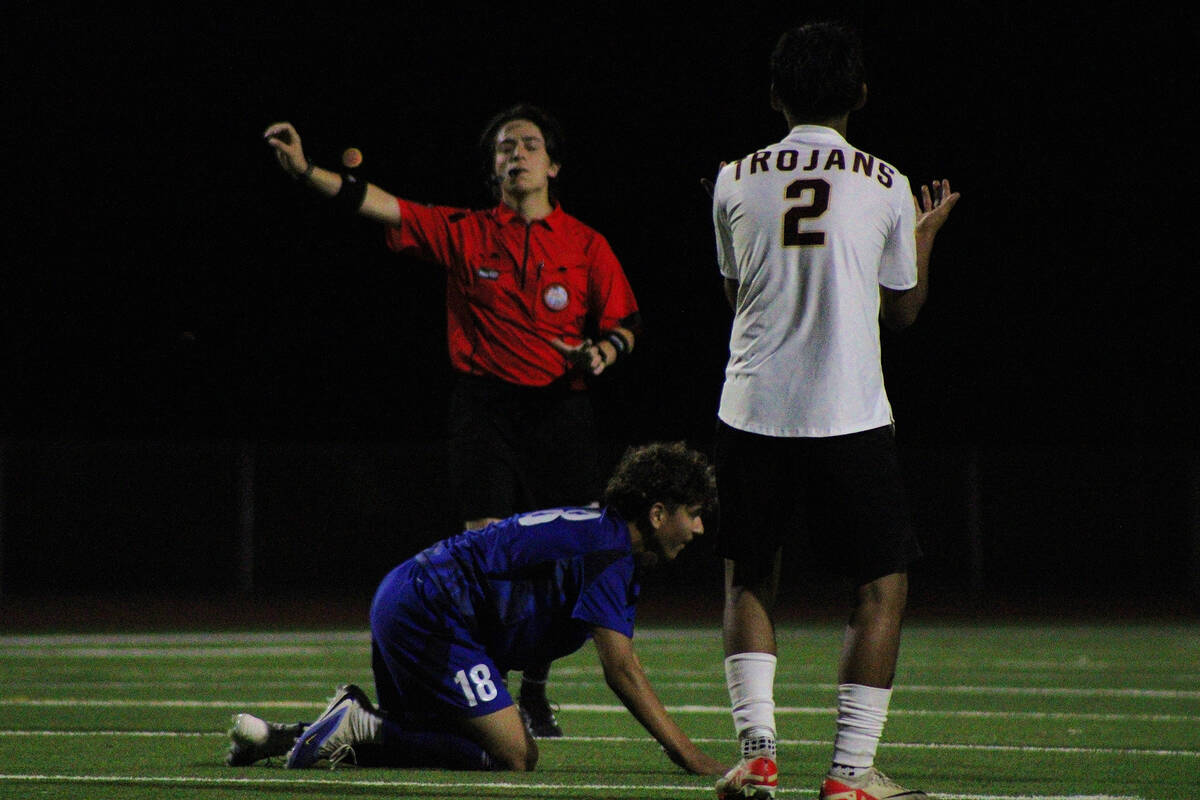 PVHS sophomore midfielder Joan Cruz pleads his case with the referee as he is called for a foul ...