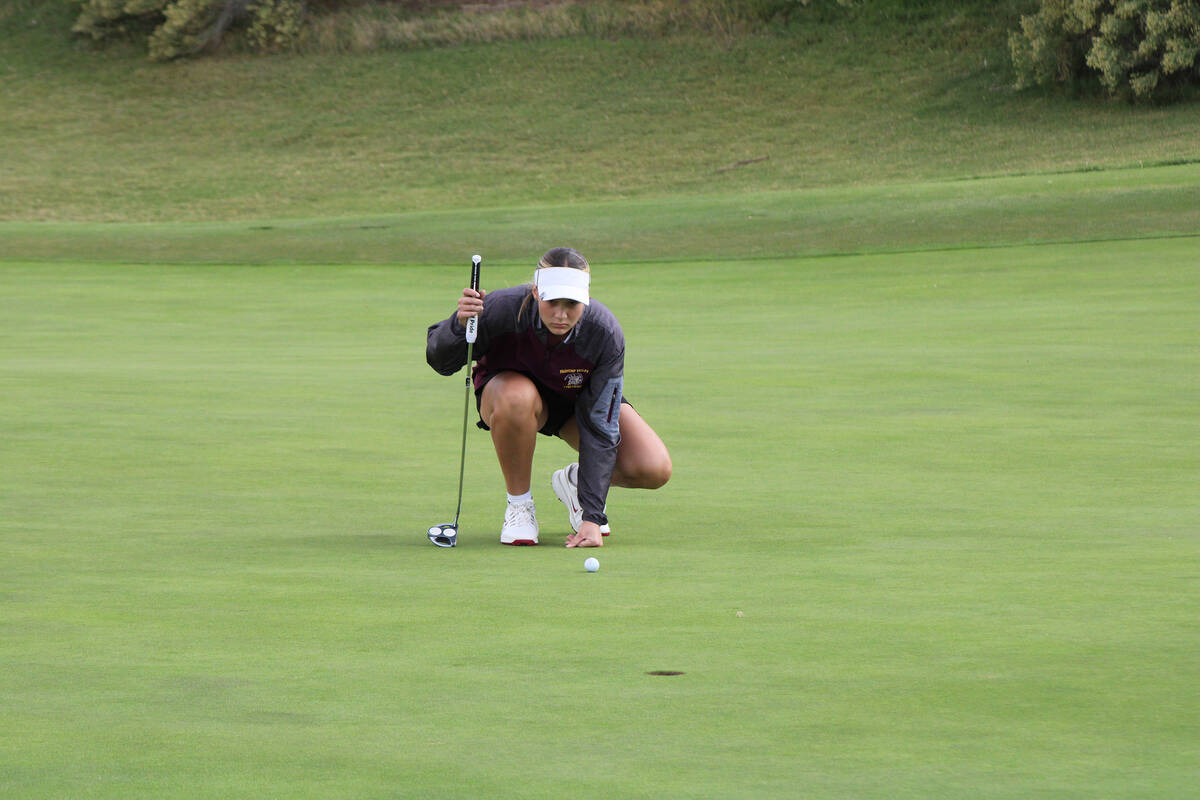 Pahrump Valley High School girls golf freshman Raegan Saldana sizes up a putt before closing ou ...