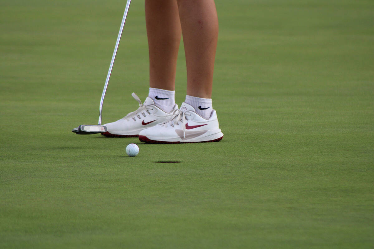 Pahrump Valley High School girls golf freshman Raegan Saldana sinks a close putt during the 3A ...