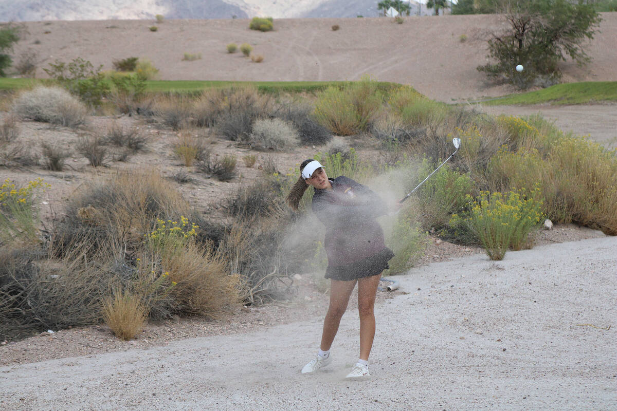 Pahrump Valley High School girls golf freshman Raegan Saldana wedges the ball out of the berm d ...