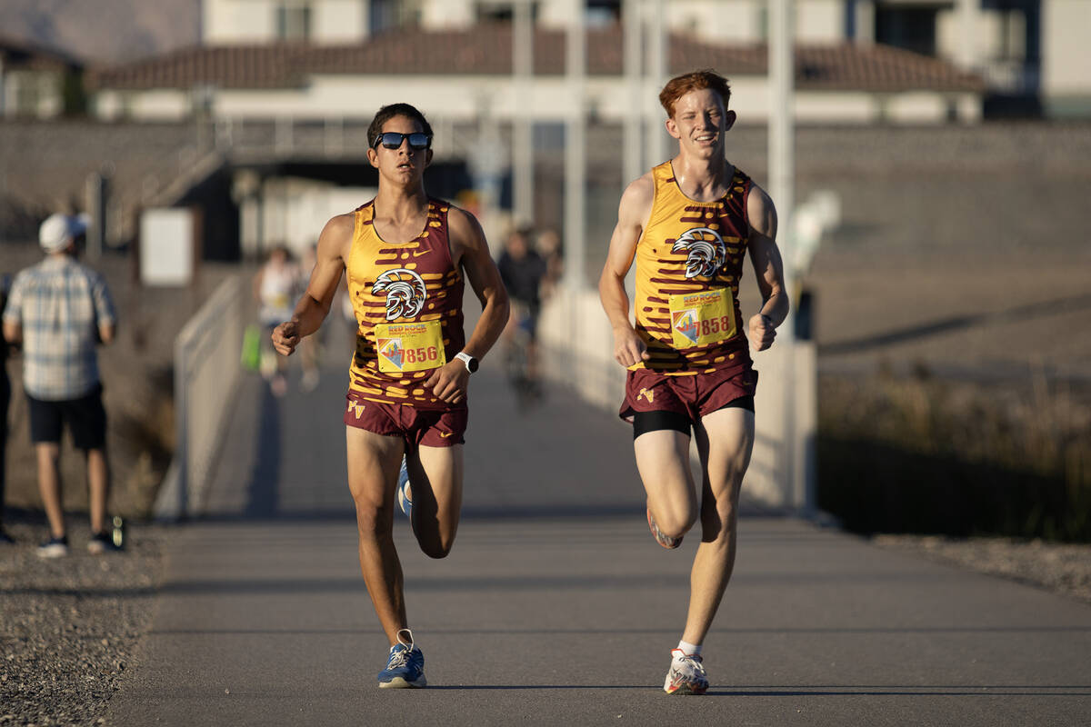 Pahrump Valley High School XC runner Joaquin Flores (left) and Joshua Gent (right) pace each ot ...
