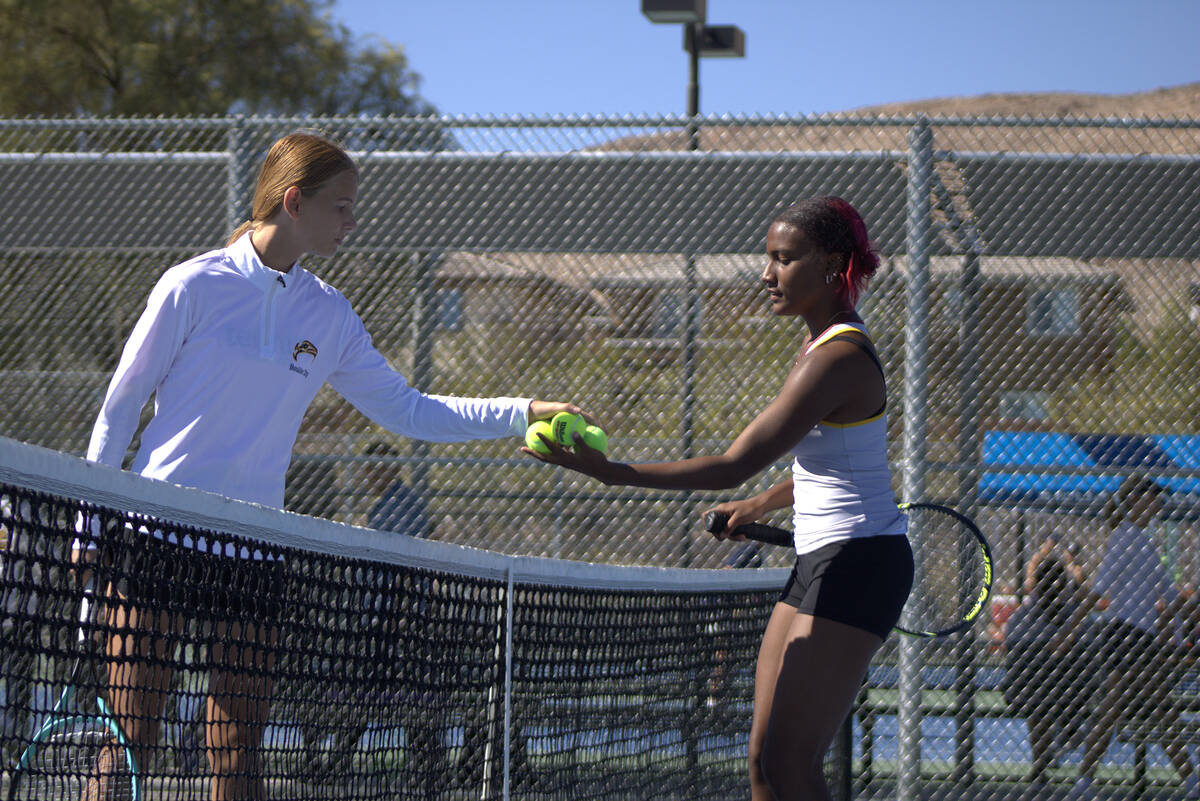 Pahrump Valley High School tennis junior Chanel Anthony is given game balls by her opponent Har ...