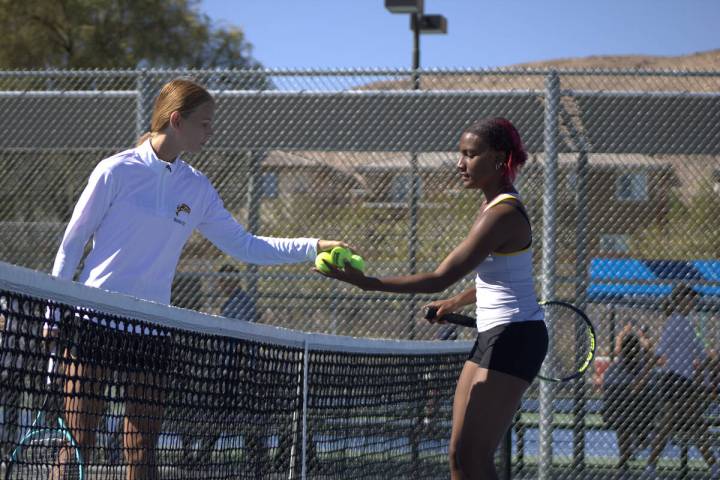 Pahrump Valley High School tennis junior Chanel Anthony is given game balls by her opponent Har ...
