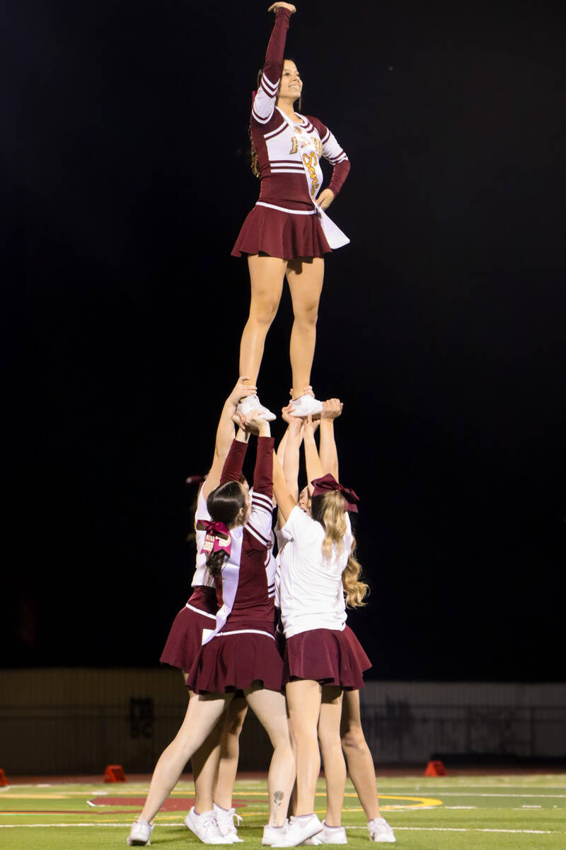 Members of the Pahrump Valley High School cheer team perform form a pyramid together during the ...