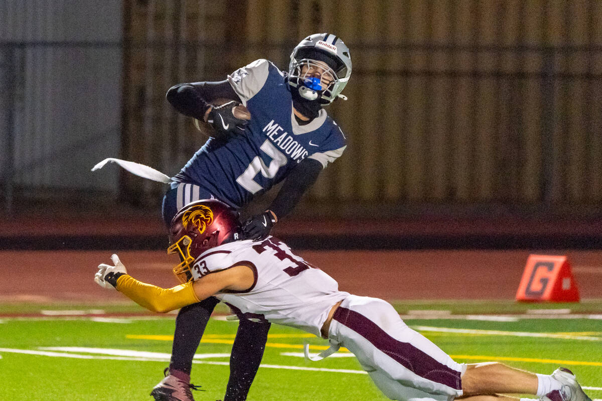 Pahrump Valley High School's ATH/WR/FS Austin Alvarez extends out fully to make a clean tackle ...