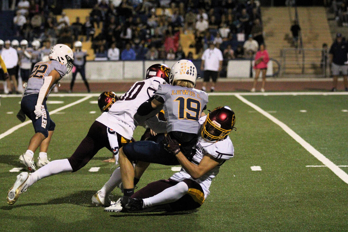 PVHS sophomore John Wydick gets a little help from Lucas Gavenda to make the tackle on Boulder ...