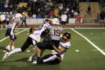 PVHS sophomore John Wydick gets a little help from Lucas Gavenda to make the tackle on Boulder ...
