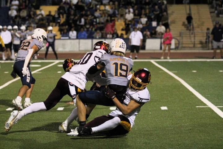 PVHS sophomore John Wydick gets a little help from Lucas Gavenda to make the tackle on Boulder ...