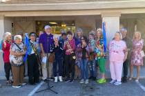 With a triumphant snip of the scissors, local shop owner Laraine Babbitt cuts the ribbon in cel ...