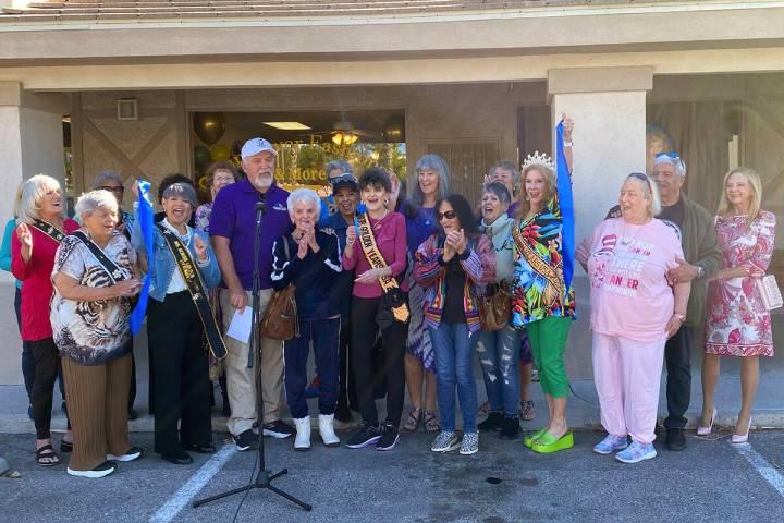 With a triumphant snip of the scissors, local shop owner Laraine Babbitt cuts the ribbon in cel ...