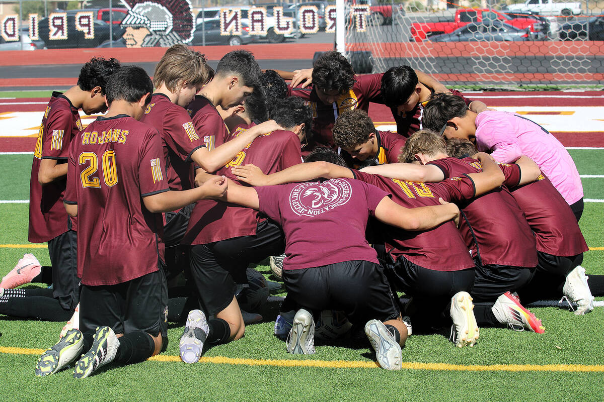 The PVHS boys soccer team comes together for a quick team prayer before their Class 3A Southern ...
