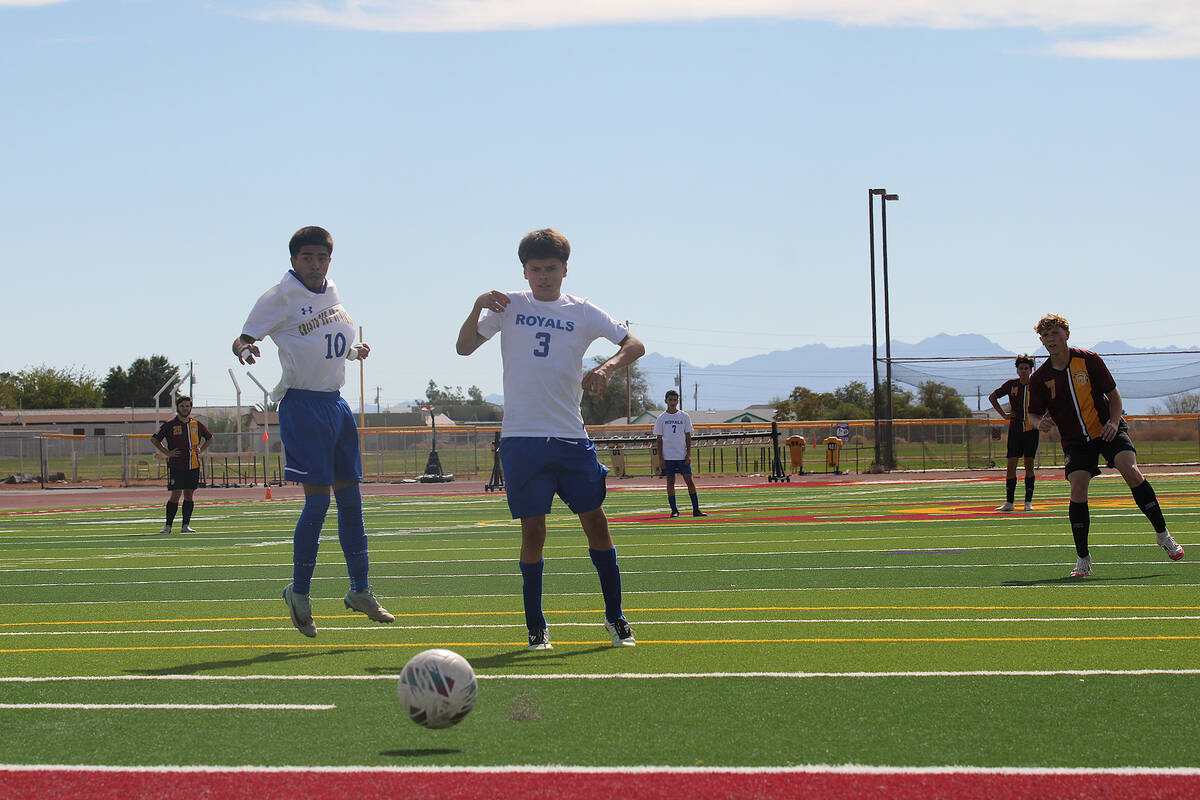 PVHS junior midfielder TC Hone sends a free kick past two Cristo Rey St. Viator defenders in a ...